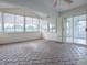 Bright sunroom featuring a ceiling fan and brick-patterned floor at 536 Grand Vista Trl, Leesburg, FL 34748