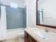 Clean bathroom, featuring a shower/tub and wood vanity at 17106 Gathering Place Cir, Clermont, FL 34711
