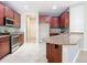 Modern kitchen featuring dark wood cabinets and granite countertops at 17106 Gathering Place Cir, Clermont, FL 34711