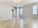 Open living room with tile floors and neutral color scheme at 17106 Gathering Place Cir, Clermont, FL 34711