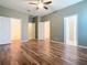 Large bedroom with wood-look tile floors and ample closet space at 17106 Gathering Place Cir, Clermont, FL 34711