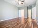 Spacious bedroom with wood-look tile floors and multiple doors at 17106 Gathering Place Cir, Clermont, FL 34711