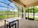 Spacious screened patio with pavers and backyard view at 17106 Gathering Place Cir, Clermont, FL 34711