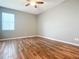 Bedroom with wood-look tile flooring and a ceiling fan at 17106 Gathering Place Cir, Clermont, FL 34711
