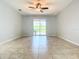 Spacious living room with tile floors and ceiling fan at 17106 Gathering Place Cir, Clermont, FL 34711