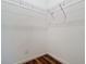 Walk-in closet with wire shelving and wood-look tile floor at 17106 Gathering Place Cir, Clermont, FL 34711