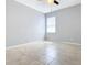 Bedroom with tile floors, ceiling fan, and gray walls at 17106 Gathering Place Cir, Clermont, FL 34711