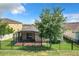 Home with fenced backyard, covered patio and mature tree at 17106 Gathering Place Cir, Clermont, FL 34711
