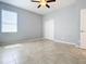 Bedroom featuring gray walls, tile floors, and a ceiling fan at 17106 Gathering Place Cir, Clermont, FL 34711