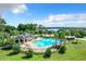 Resort-style community pool with cabana and lounge chairs at 17106 Gathering Place Cir, Clermont, FL 34711