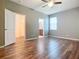 Primary bedroom with wood-look tile floors and ensuite bathroom at 17106 Gathering Place Cir, Clermont, FL 34711