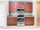 Well-equipped kitchen with stainless steel appliances and wood cabinets at 17106 Gathering Place Cir, Clermont, FL 34711