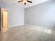 Spacious bedroom with gray walls, tile floors, and ceiling fan at 17106 Gathering Place Cir, Clermont, FL 34711