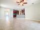 Spacious living room with tile floors and kitchen view at 17106 Gathering Place Cir, Clermont, FL 34711