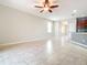 Open living room with tile floors and kitchen view at 17106 Gathering Place Cir, Clermont, FL 34711