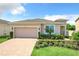 Two-story house with a two-car garage and landscaped yard at 17106 Gathering Place Cir, Clermont, FL 34711