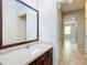Bathroom with wood vanity and a large mirror at 17106 Gathering Place Cir, Clermont, FL 34711