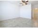 Spacious bedroom featuring tile floors and a ceiling fan at 17106 Gathering Place Cir, Clermont, FL 34711