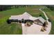 An aerial view showcasing a home's exterior, landscaping, and driveway at 2499 Nw 102Nd Blvd, Wildwood, FL 34785