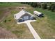 Aerial view of a barn, covered shelter, and spacious grounds at 2499 Nw 102Nd Blvd, Wildwood, FL 34785