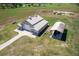 Aerial view of a barn with a covered shelter; large property at 2499 Nw 102Nd Blvd, Wildwood, FL 34785