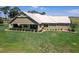 Single-story home with covered patio and meticulously landscaped yard at 2499 Nw 102Nd Blvd, Wildwood, FL 34785