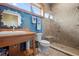 Bathroom with walk-in shower, toilet and wooden vanity at 2499 Nw 102Nd Blvd, Wildwood, FL 34785