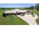 Aerial view of a luxurious ranch-style home with a large yard and detached garage at 2499 Nw 102Nd Blvd, Wildwood, FL 34785