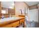 Small bathroom with shower, toilet and wooden vanity at 2499 Nw 102Nd Blvd, Wildwood, FL 34785