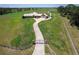 Aerial view of a home with a long driveway and gated entrance at 2499 Nw 102Nd Blvd, Wildwood, FL 34785