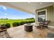 Spacious covered patio with fire pit and wicker furniture, offering tranquil views at 2499 Nw 102Nd Blvd, Wildwood, FL 34785