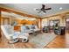 Open living room with hardwood floors, comfortable seating, and views of the kitchen at 2499 Nw 102Nd Blvd, Wildwood, FL 34785
