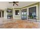Covered patio features a TV, comfortable seating and access to the backyard at 2499 Nw 102Nd Blvd, Wildwood, FL 34785