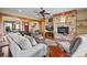 Living room features a stone fireplace, hardwood floors, and comfortable seating at 2499 Nw 102Nd Blvd, Wildwood, FL 34785