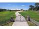 Ornate metal gate leading to a charming home on a large property at 2499 Nw 102Nd Blvd, Wildwood, FL 34785
