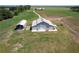 Aerial view of a barn, shelter, and surrounding land at 2499 Nw 102Nd Blvd, Wildwood, FL 34785