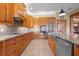 Spacious kitchen with wood cabinets, granite countertops, and stainless steel appliances at 2499 Nw 102Nd Blvd, Wildwood, FL 34785