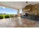 Outdoor kitchen with built-in grill, granite countertops, and ample cabinet space at 2499 Nw 102Nd Blvd, Wildwood, FL 34785