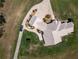 Aerial view of a house and expansive property with a long driveway at 2499 Nw 102Nd Blvd, Wildwood, FL 34785