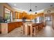 Large kitchen with island, wood cabinets, granite countertops, and stainless steel appliances at 2499 Nw 102Nd Blvd, Wildwood, FL 34785