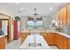 Kitchen features island with sink, breakfast bar, and view to backyard at 4114 Dove Valley Ln, Lady Lake, FL 32159