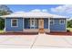 Blue house with metal roof and front porch at 4114 Dove Valley Ln, Lady Lake, FL 32159