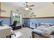 Bright bedroom with a window view, workspace, and bed at 4114 Dove Valley Ln, Lady Lake, FL 32159