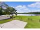 Peaceful lake view from backyard, with grassy area and shed at 4114 Dove Valley Ln, Lady Lake, FL 32159