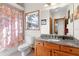 Clean bathroom with granite countertop and wooden cabinets at 4114 Dove Valley Ln, Lady Lake, FL 32159