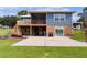 Two-story house with a large deck, screened porch, and brick base at 4114 Dove Valley Ln, Lady Lake, FL 32159