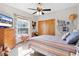 Cozy bedroom with lake view, ceiling fan and dresser at 4114 Dove Valley Ln, Lady Lake, FL 32159