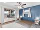 Spacious bedroom with two windows, hardwood floors, and side tables at 4114 Dove Valley Ln, Lady Lake, FL 32159
