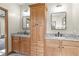Bathroom with double vanity, granite countertop, and large storage cabinet at 4114 Dove Valley Ln, Lady Lake, FL 32159