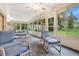 Bright sunroom with multiple seating options and access to the backyard at 6435 Borg St, Leesburg, FL 34748